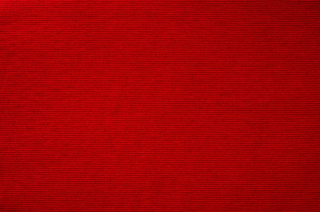 Red fabric closeup background with visible texture or pattern.の写真素材