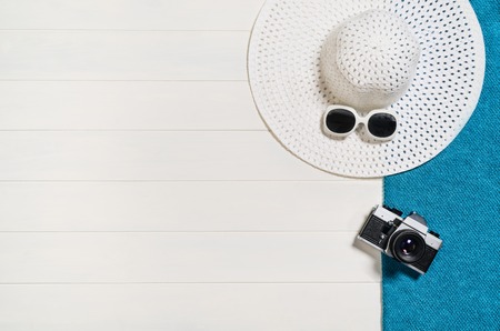 Top view of beach summer accessories with copy space. Lay flat holiday fashion background on white wooden table or floor. Horizontal frame for spa or wellness concept.の写真素材