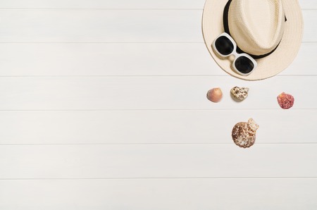 Top view of beach summer accessories with copy space. Lay flat holiday fashion background on white wooden table or floor. Horizontal frame for spa or wellness concept.の写真素材