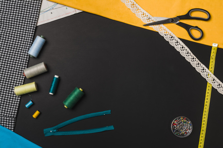 Background with sewing and knitting tools and accesories. Set for needlework placed on chalkboard....