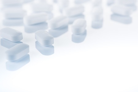 Medical concept or theme image with pills in the foreground. Product photo taken from above, low...