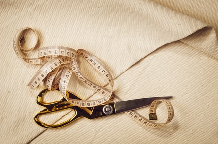 Background with sewing and knitting tools and accesories. Set for needlework placed on flax fabric....