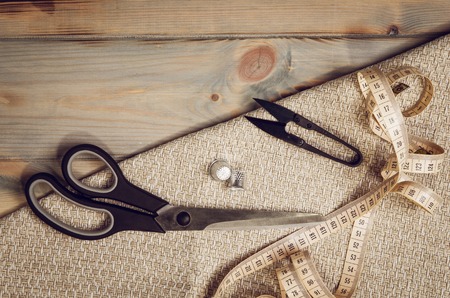 Background with sewing and knitting tools and accesories. Set for needlework placed on flax fabric. Image taken from above, top view. A lot of copyspace.の写真素材
