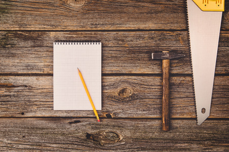 Construction equipment and tools background on wooden table. Concept photograph taken from above, top view. Do it yourself theme.の写真素材