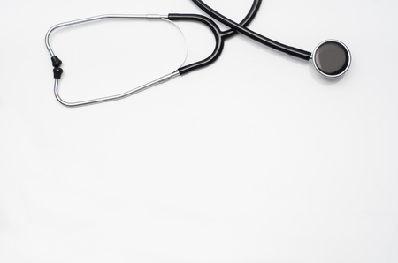 Top view of modern, sterile doctors office desk. Medical accessories on a white table background with copy space around products. Photo taken from above.の写真素材