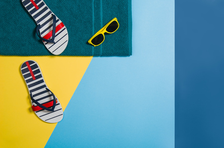 Top view of colorful, graphical sandy beach with summer accessories and copy space around products. Blank mock up for advertising or packaging. Colourful frame with graphical backdropの写真素材