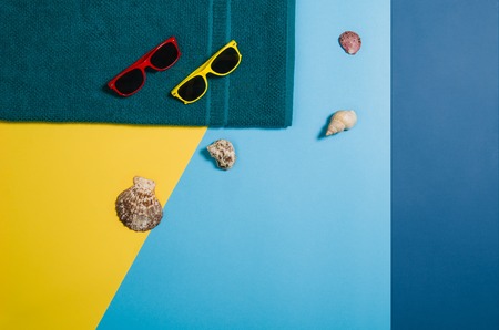 Top view of colorful, graphical sandy beach with summer accessories and copy space around products. Blank mock up for advertising or packaging. Colourful frame with graphical backdropの写真素材