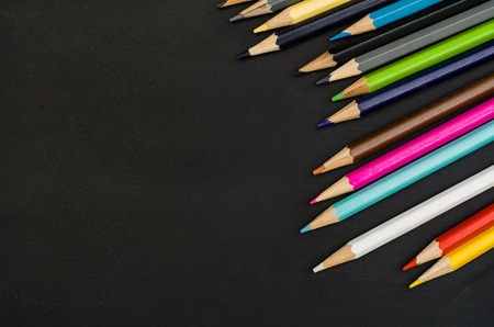 School supplies border on black chalkboard background. Top view product photograph with copy space for text or design. Back to school, education conceptの写真素材