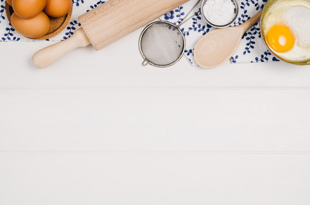 Baking a cake or pizza ingredients background. Top view photograph with kitchen utensils on vintage,...