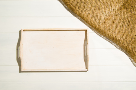 Product photo of white, painted, wooden floor with jute linen cloth. Visible texture background. Studio image taken from above, top view.の写真素材
