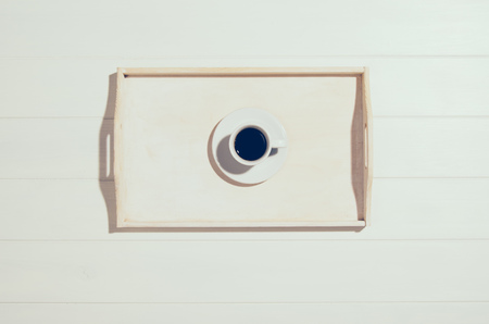 Coffee mug on white wooden table top view. Filtered vintage effect photographの写真素材