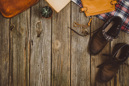 Accessories for travel top view on wooden background with copy space. Adventure and wanderlust concept image with travel accessories. Preparing for an exotic trip, journey and sightseeing.の写真素材