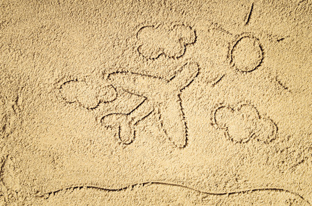 Top view of sandy beach with drawing in the sand or symbol. Background with copy space and visible sand texture.の写真素材