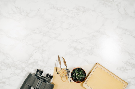 Accessories for travel top view on white natural marble background with copy space. Adventure and wanderlust concept image with accessories. Traveler preparing for an exotic trip and journey.の写真素材