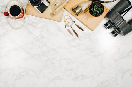 Accessories for travel top view on white natural marble background with copy space. Adventure and wanderlust concept image with accessories. Traveler preparing for an exotic trip and journey.の写真素材