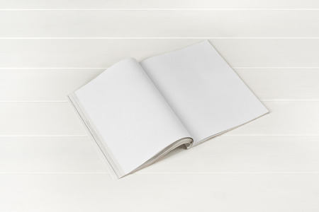 Mock-up magazine or catalog on white wooden table. Blank page or notepad on wood background. Blank page or notepad for mockups or simulations.の写真素材