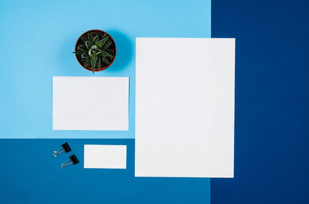 Mock-up magazine or catalog on colorful table. White page or notepad on modern background. Blank copy space for mockups or simulations.の写真素材