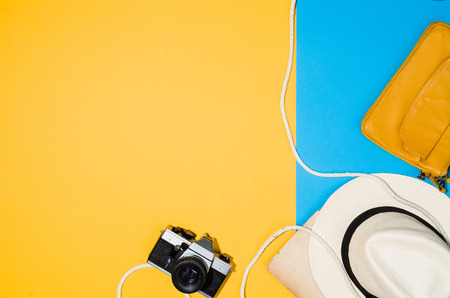 Travel accessories top view on colorful background with copy space. Lay flat woman traveler products on blue and yellow seamlessの写真素材