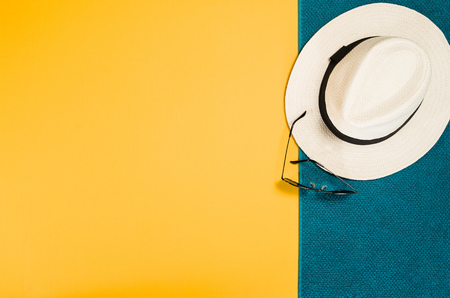 Accessories for travel top view on yellow background with copy space. Beach adventure and wanderlust concept image with travel accessories. Sunbathing and relaxingの写真素材