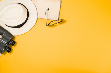Accessories for travel top view on yellow background with copy space. Beach adventure and wanderlust concept image with travel accessories. Sunbathing and relaxingの写真素材