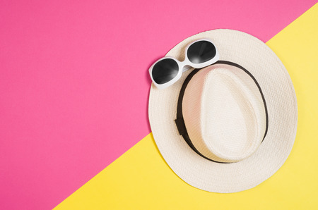 Womans accessories lying flat on pink paper table background. Pastel colors with copy space around products . Image taken from above, top view. Minimal style with room for textの写真素材