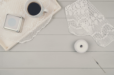 Top view of grey wooden table with crocketing accessories. Visible wood texture and copy space around products. Knitting concept background.の写真素材