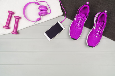 Sport and fitness accessories, healthy and active lifestyle concept on wooden floor background with copy space. Products with vibrant, punchy pastel colours. Image taken from above, top view.の写真素材