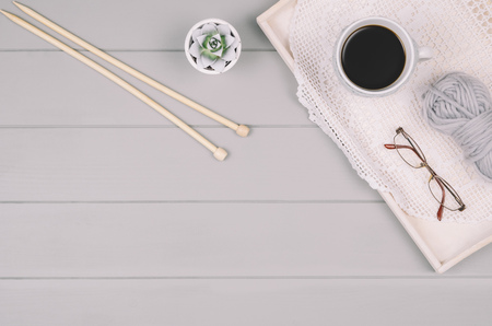 Knitting accessories assortment background with wool and needles on gray wooden table. Photograph taken from above top view. Frame composition with copy space around products.の写真素材