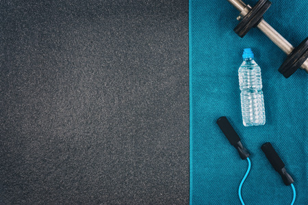 Fitness or bodybuilding concept background. Product photograph of old iron dumbbells on black grey,...