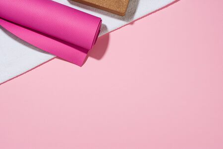 Yoga or fitness accessories on paper background, lifestyle concept photograph. Top view sports...