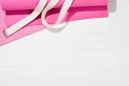 Yoga or fitness accessories on paper background, lifestyle concept photograph. Top view sports...