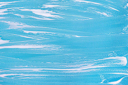 Cleaning background texture - chemical soap detergent foam on a clear glass