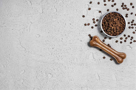 Dog pet food and accessories on concrete background top view.の写真素材