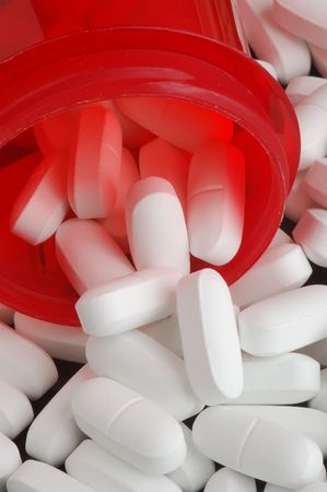Prescription bottle with white tablets