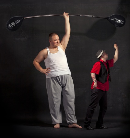 Strong man lifting a balloon barbell on the stage の写真素材