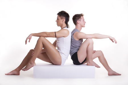 Gay couple sitting back to back の写真素材