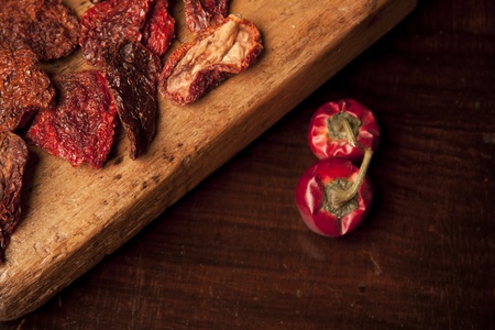 sun-dried tomatoes on wood cutting boardの写真素材