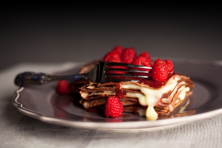 Chocholate raspberry pancake dessert on an table cover.の写真素材