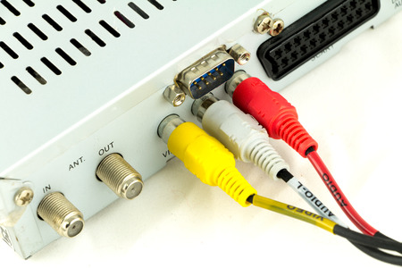 Person connecting AV cables at the back of device