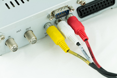 Person connecting AV cables at the back of deviceの写真素材