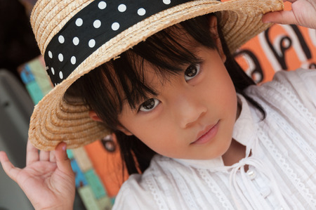 Portrait of little girl wearing a hatの写真素材