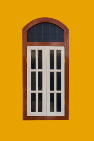 A vintage window on yellow wallの写真素材