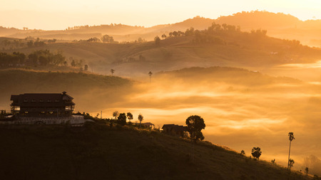 Sunrise Fog and ray on the hillの写真素材
