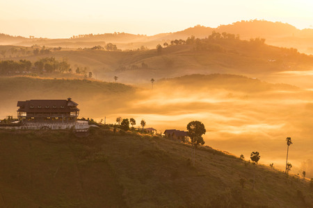Sunrise Fog and ray on the hillの写真素材
