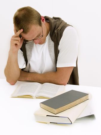 A young student working on his homeworkの写真素材
