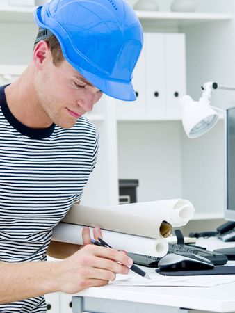 construction worker looking at the diagrams and blueprintsの写真素材