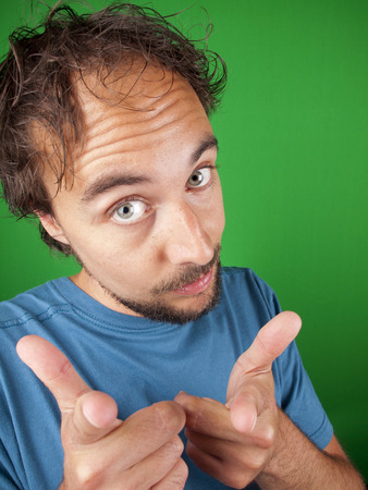 Man with a beard pointing at you over a green backgroundの写真素材