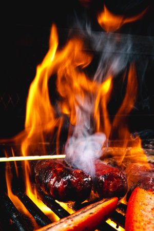 Whole and cut sausages on the grill.の写真素材