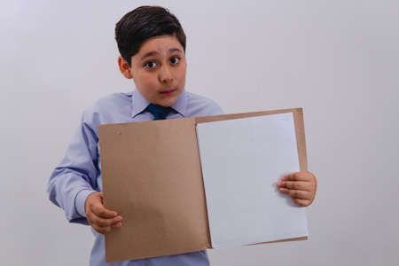 Boy dressed as a businessman with a shirt and a tie with an open folder with sheets that are blank...