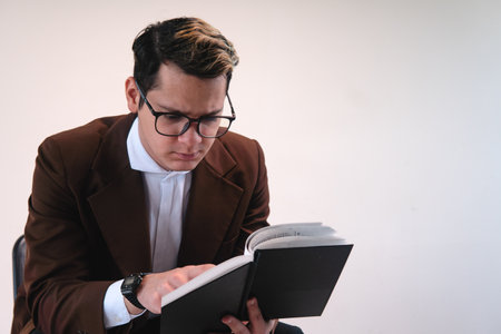 Smartly dressed studious man. Man dressed in brown jacket, white shirt, glasses and on a white...